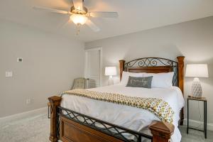 a bedroom with a bed with a ceiling fan at Updated Greenville Home with Deck about 1 Mi to Downtown in Greenville
