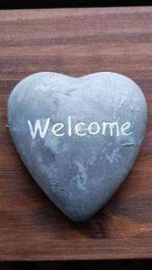 a heart shaped stone with the word welcome on it at A la Maison d'Hôtes in La Baume-de-Transit