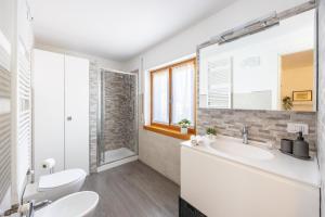 a bathroom with two sinks and a shower at Close to Duomo with wonderful terrace in Milan
