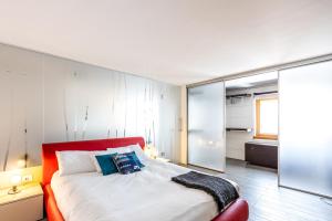 a bedroom with a bed with a red headboard at Close to Duomo with wonderful terrace in Milan