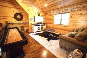 uma sala de estar num chalé de madeira em 4BR/3Bth family cabin with a hot tub, sleeps 14 em Broken Bow