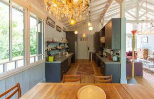 a kitchen with a table and a dining room at VILLA LOLITA pour 6 PERS AU CAP FERRET in Cap-Ferret