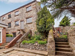 a stone house with stairs in front of it at 3 bed in Wirksworth 83082 in Wirksworth