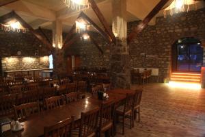 a dining room with a large wooden table and chairs at Aqua Boss Hotel in Eceabat