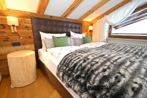 a large bed in a room with a window at Alp-Chalet in Hirschegg +74 photos