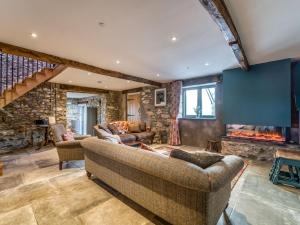 a living room with two couches and a fireplace at 4 Bed in Denbigh 76475 in Llannefydd