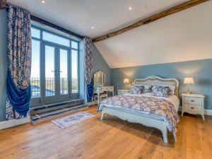 a bedroom with a bed and a large window at 4 Bed in Denbigh 76475 in Llannefydd