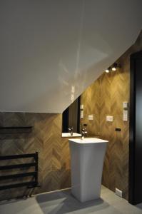 a bathroom with a white sink and wooden walls at Leśny Zakątek in Poronin +34 photos