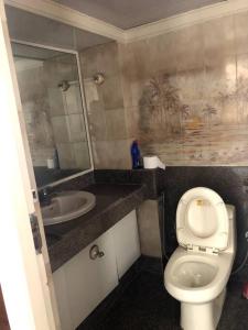 a small bathroom with a toilet and a sink at Sealink view Apartment next to Hinduja Hospital in Mumbai
