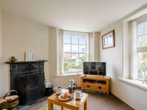 a living room with a fireplace and a tv at 1 bed in Eskdale SZ503 in Beckfoot