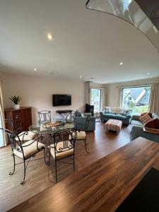 a living room with a table and chairs at Highland Holiday Home in Contin