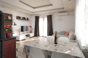 a living room with a dining table and a living room with a couch at Melani in Mošćenička Draga