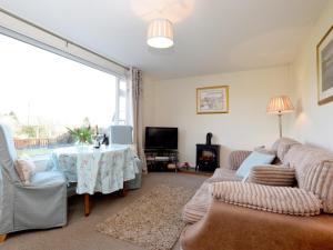 a living room with a couch and a table at 1 Bed in Hawkshead Village LLH16 in Hawkshead