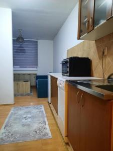 a kitchen with a sink and a microwave at Apartment Lamele Bugojno in Bugojno