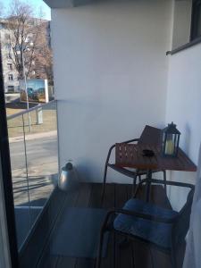 a small table and two chairs on a balcony at 2 izbový luxusný apartmán v novostavbe v centre mesta in Banská Bystrica