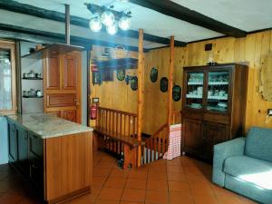 a kitchen with a counter and a couch in a room at Appartamento CHAMPORCHER in Champorcher