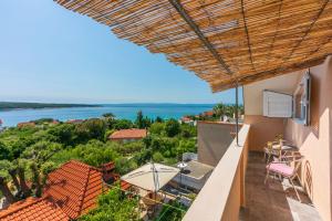 a balcony of a house with a view of the water at Apartments Ljiljana in Supetarska Draga