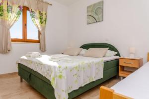 Postel nebo postele na pokoji v ubytování Apartments Toni