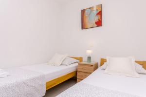 Postel nebo postele na pokoji v ubytování Apartments Toni
