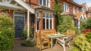 a patio with a table and chairs in front of a house at Thalassa in Walberswick