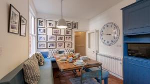 a dining room with a table and a clock on the wall at Thalassa in Walberswick