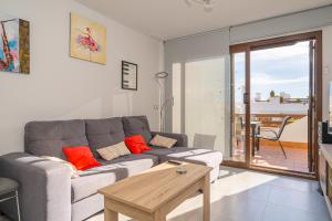 a living room with a couch and a table at Casa Musica in San Juan de los Terreros