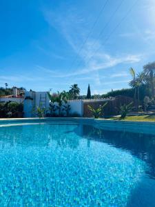 a large swimming pool with blue water at Casa Avellana 37 in Denia