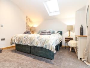 a bedroom with a bed and a skylight at La Petit Maison in Saint Columb Major