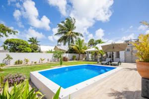 a swimming pool in the backyard of a house at Quaint 4BDR villa with pool in Grand Gaube in Grande Gaube