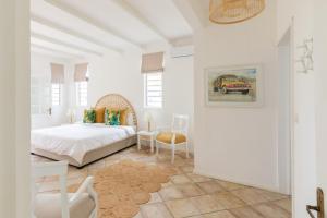 a white bedroom with a bed and a table at Quaint 4BDR villa with pool in Grand Gaube in Grand Gaube