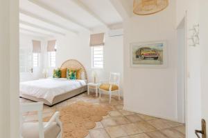 a white bedroom with a bed and a table at Quaint 4BDR villa with pool in Grand Gaube in Grand Gaube +58 photos