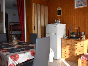 a kitchen with a white refrigerator next to a bedroom at Studio Font-Romeu-Odeillo-Via, 1 pièce, 4 personnes - FR-1-580-86 in Font-Romeu-Odeillo-Via