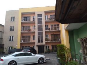 a white car parked in front of a building at St Theresa apartment Lodge in Lagos