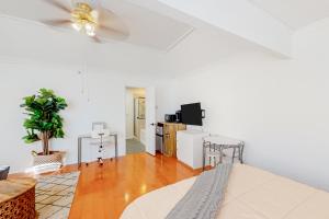 a living room with white walls and wooden floors at Restful City Living, Unit B in Dallas