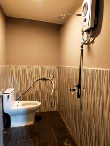 a bathroom with a shower and a toilet in it at LD SWEET HOMESTAY LAHAD DATU in Lahad Datu