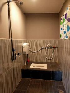 a bathroom with a shower with a toilet in it at LD SWEET HOMESTAY LAHAD DATU in Lahad Datu