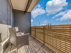 a balcony with two chairs and a fence at 6 min to UT Southwestern_Fast Wi-fi in Dallas