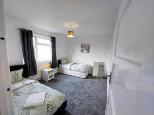 a bedroom with two beds and a window at 3 bedroom Flat in Hoxton London in London
