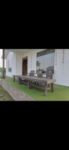 a large wooden bench in front of a building at MB farms in Greater Noida