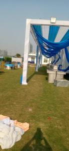 a mattress laying on the grass under a tent at MB farms in Greater Noida