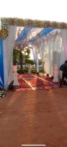 a row of white tents with blue and white curtains at MB farms in Greater Noida