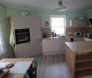 a kitchen with a white refrigerator and a table at Apartment Am Mittelpunkt Deutschlands in Niederdorla +30 photos