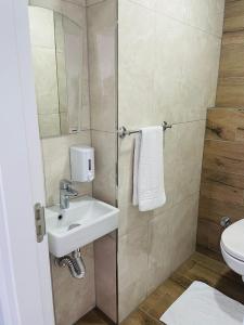 a small bathroom with a sink and a shower at Apart Angel Suit 5 in Nevsehir