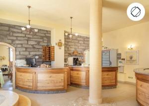 a kitchen with wooden counters and a stone wall at Antico Borgo Petralia in Zafferana Etnea