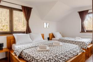 zwei Betten in einem Zimmer mit zwei Laptops darauf in der Unterkunft Šumski raj in Desmerice