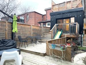 a patio with a table and chairs and a playground at Bright 3 bedroom house Downtown in Toronto
