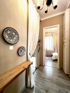 a hallway with a table and a plate on the wall at Le Parisien - Chic 2BR City Centre Escape in Tangier