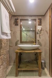 a bathroom with a sink and a mirror at Passage Art Hotel in Baku