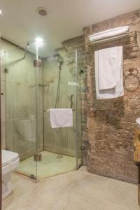 a bathroom with a shower with a glass door at Passage Art Hotel in Baku