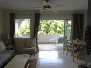 a living room with a couch and a table at Golden View Apartment in Saint James